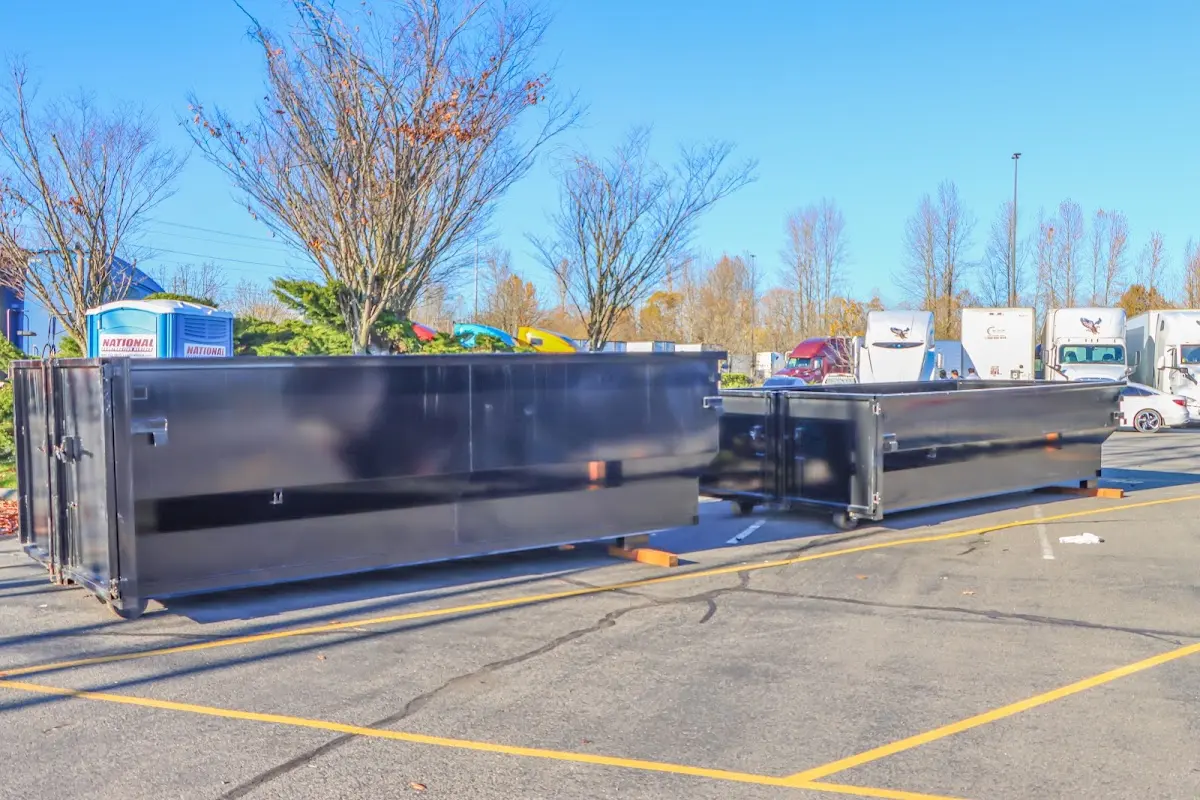 Professional dumpster rental service with roll-off container on residential driveway in Leawood